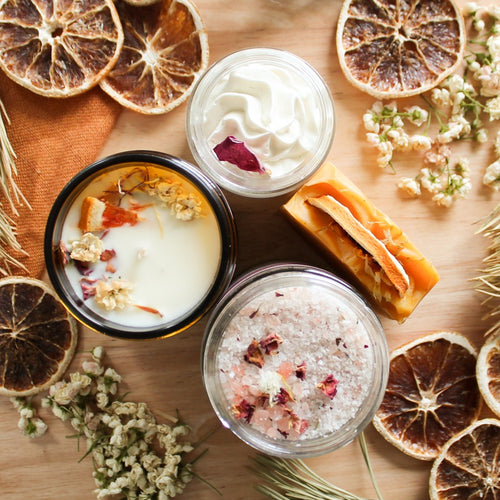 Coffret bien-être de produits pour le corps et d'ambiance énergisant, chandelle, sels de bain, beurre fouetté et savon, décoré de fleurs et de feuilles