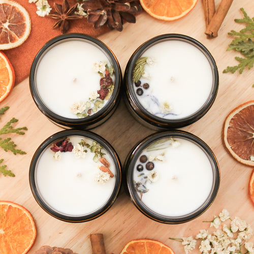 Ensemble de chandelles hivernales, faites de cire de soya et de coco et d'huiles essentielles, décorées de fleurs et feuilles, dans une boîte cadeau